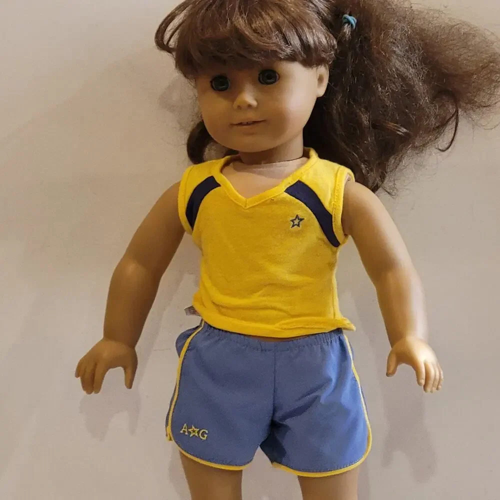 American Girl Doll Grey eyes light brown hair.